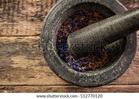 Mortar of healing herbs, herbal tea assortment and dry on table. Herbal medicine.