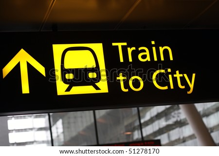 Airport sign with train to city directions