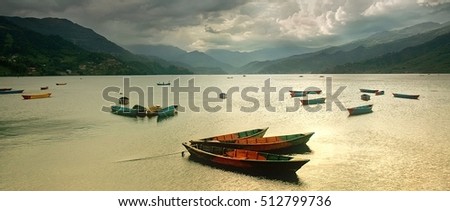 Colorful rowing boats on the Phewa Lake, Nepal. Natural lighting, natural colors