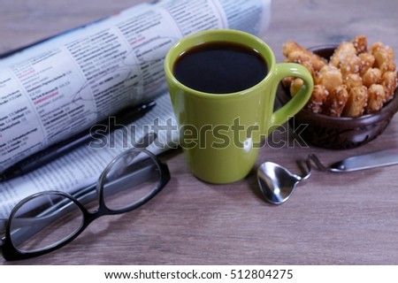 Cup of hot coffee on a "good day" and a morning newspaper - selective focus