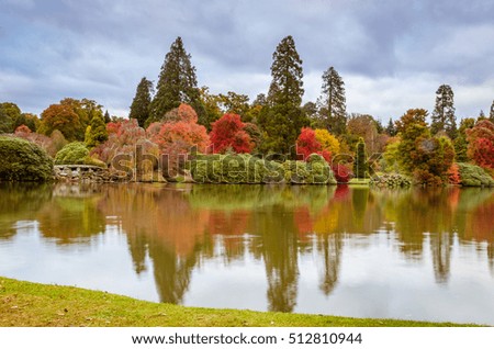 Autumnal landscape of trees reflected on water.Picture taken on Sheffield Park Garden