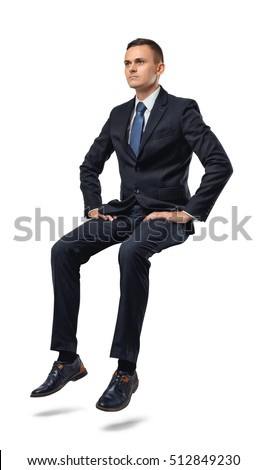 Cut-out full portrait of a businessman sitting on an invisible surface. Confident pose. Determination and perseverance. Confidence in the correctness of its decision. Reliable support. Royalty-Free Stock Photo #512849230