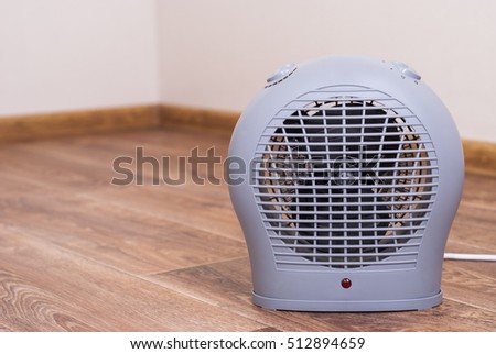 Portable electric heater fan type is on the floor Royalty-Free Stock Photo #512894659