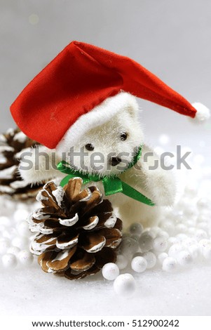 Winter background.White teddy bear with Santa Claus ' red hat