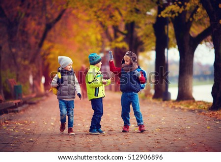 three schoolboys walking on the street