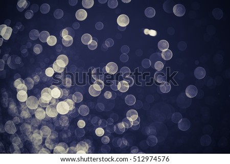 abstract blue bokeh background. bokeh of water fly and lights on black background.Blue Festive Christmas elegant abstract background. Vintage