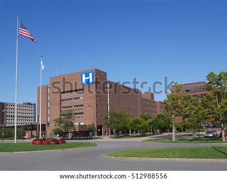 large modern building with H sign for hospital