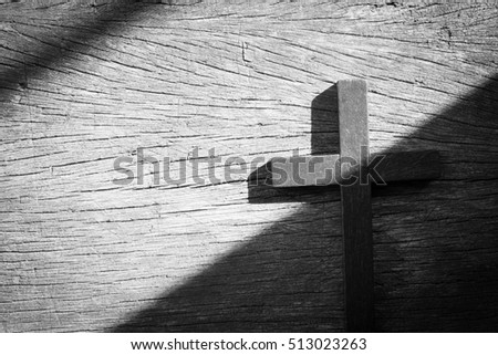 Image of wooden cross on old wooden background, black and white tone