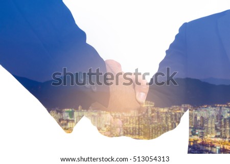 Double exposure of handshake and city.Business handshake and business people concept.