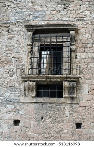 Classical window with ornaments on a stone wall