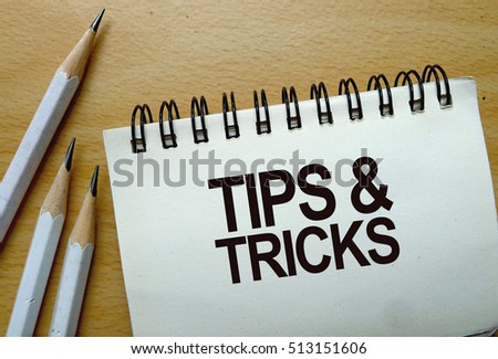 Tips & Tricks text written on a notebook with pencils