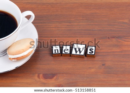 Coffee cup on a wooden table and text - News
