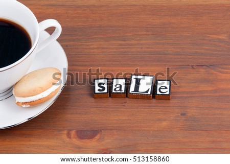 Coffee cup on a wooden table and text - Sale