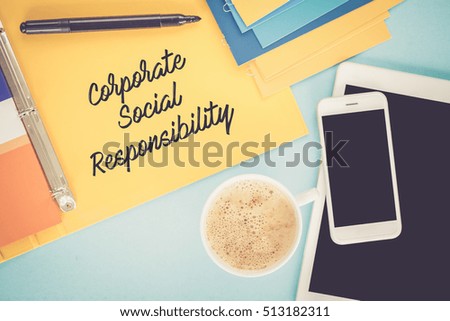 Notepad on workplace table and written CORPORATE SOCIAL RESPONSIBILITY concept