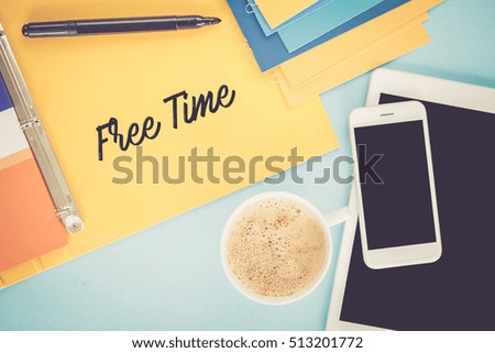 Notepad on workplace table and written FREE TIME concept