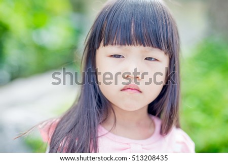 little girl angry in the park,asia