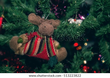 Christmas decoration, a reindeer hanging on a branch of Christmas tree. Winter holidays.