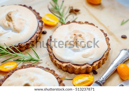 Healthy Christmas Meringue Tartlets with Orange Jam and Rosemary on the Light Wooden Background, Close Up View