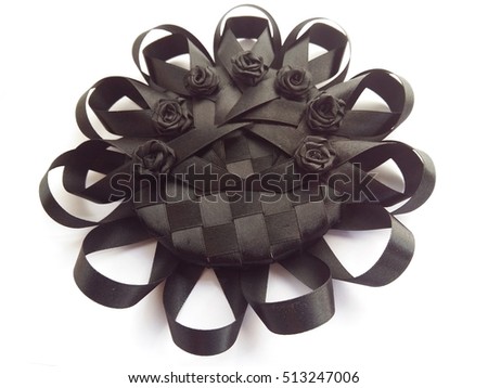 Black ribbon in sunflower shape on white background