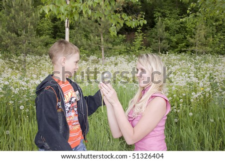 Little boy and mother on a green meadow