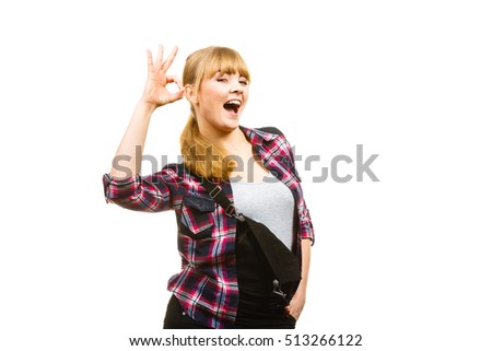 Gardening concept. Attractive woman in dungarees and pink check shirt showing a ok gesture. Isolated background