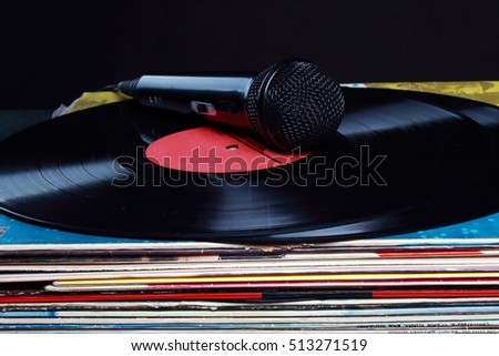 black microphone lying on vinyl