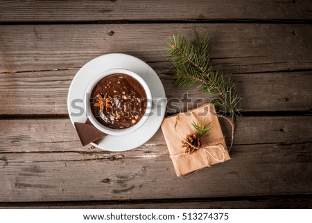 Hot chocolate mug and present on rustic table, top view copy space