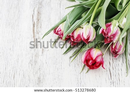 Beautiful pink tulips on wooden background. Copy space