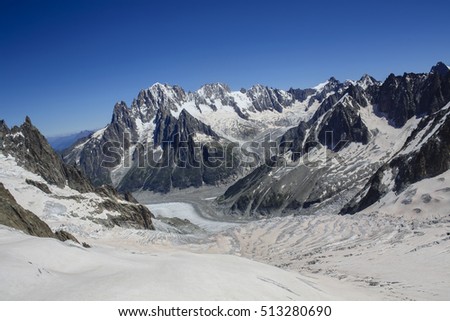 aerial view of the Alps and of the Mont Blanc from the Tramway of Mont Blanc overlooking alpinists,hikers,climbers and crevasses during a sunny day in summer - Chamonix Mont Blanc - France