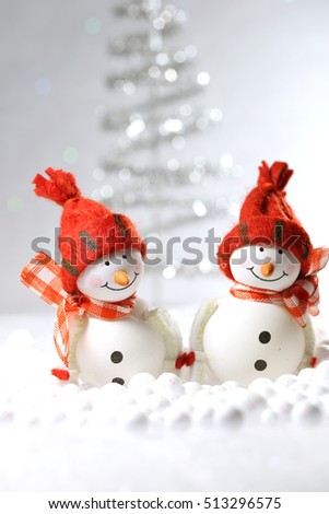 Cute smiling snowmen with a winter background