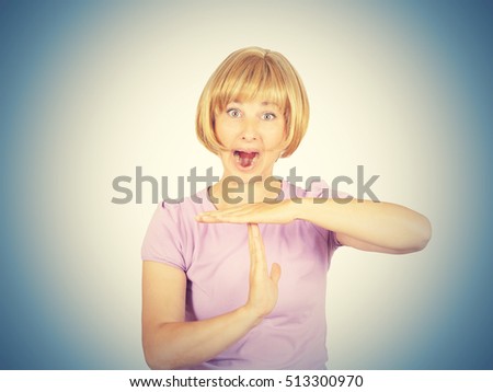 Portrait, young, woman shouts showing time out gesture with hands isolated . human emotion facial expression body language reaction