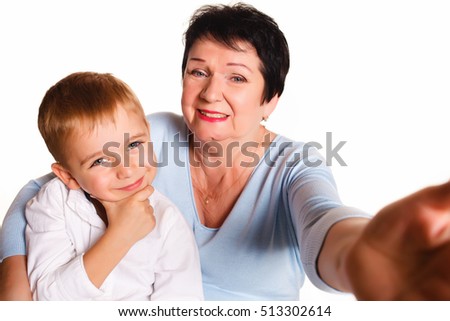 Grandmother and grandson make selfie photo studio on a white background