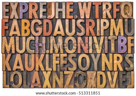 alphabet abstract in antique letterpress wood type printing blocks stained by color inks, isolated on white Royalty-Free Stock Photo #513311851