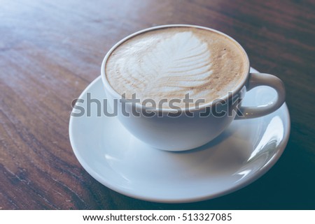 Cup of hot coffee put on old wood wooden table background.Vintage tone with copy space.