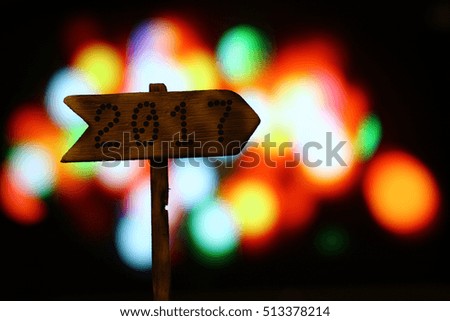 Wood sign 2017 in right on Christmas bokeh lights background,concept of a start to new year.