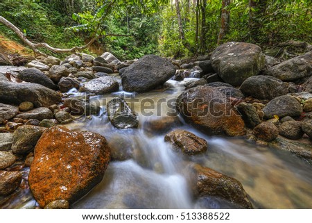 Water stream at Hutan Lipur Ulu Bendul, Malaysia. Image contain grain, noise and soft focus due nature composition.