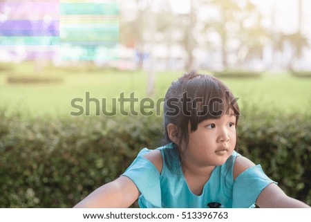 Portrait asian smiling little girl having fun at the park with copy space
