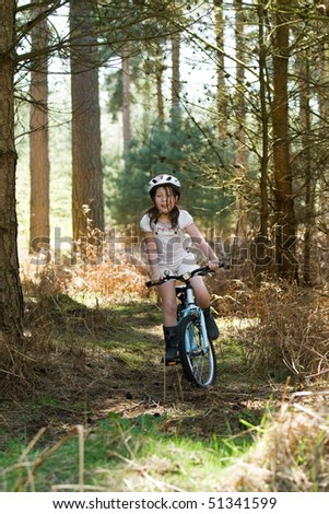 Shot of a Young Girl Riding her Bike in the Forest