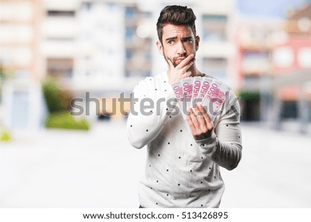 young man holding bills