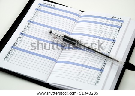 stock photos of an open daily planner with a pen