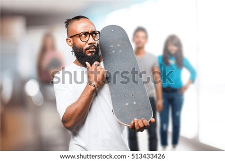 black man thinking with a skateboard