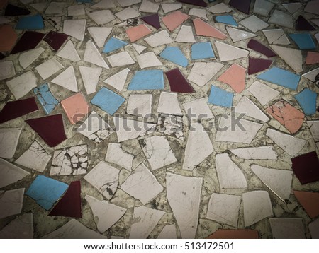 Many pieces of ceramic tile on concrete floor. Old floor cracking for textures and background.