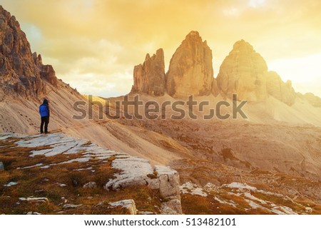 Tre Cime di Lavaredo in beautiful surroundings at lonely man  in the Dolomites at sunset in Italy, Europe (Drei Zinnen) Royalty-Free Stock Photo #513482101