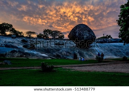 Krishna's butterball has sat in the same spot for the last 1200 years. AMAZING. Its located in India's sculptural capital,  Mahabalipuram. I shot it during sunset but was scared it'd roll right on me. Royalty-Free Stock Photo #513488779