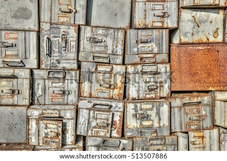 Pile of vintage military metal trunks