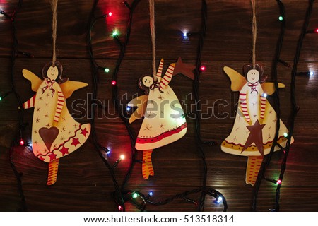 Christmas tree toys, angel. christmas decoration handmade toy Angel. christmas decoration handmade toys hanging over rustic wooden background.