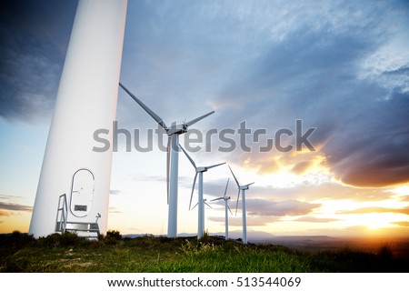 Windmills for electric power production at sunset, Zaragoza Province, Aragon, Spain. Royalty-Free Stock Photo #513544069