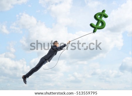 A businessman floating up in the sky holding a big dollar sign on a string. Way to success. Earning money. Business and finance.