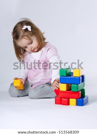 little girl playing with cubes
