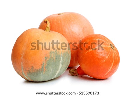 three orange pumpkins on white background